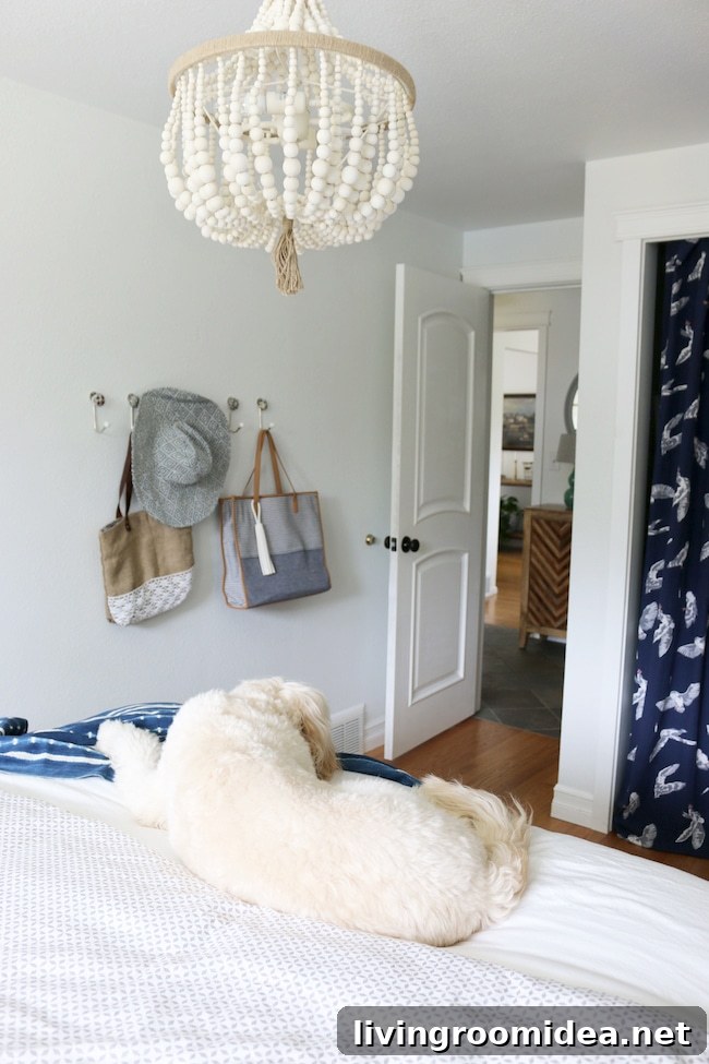 Beaded chandelier over bed - small coastal cottage guest room