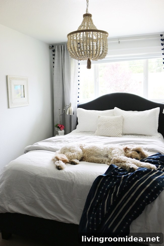 Small coastal cottage guest room makeover. White walls, beaded chandelier.