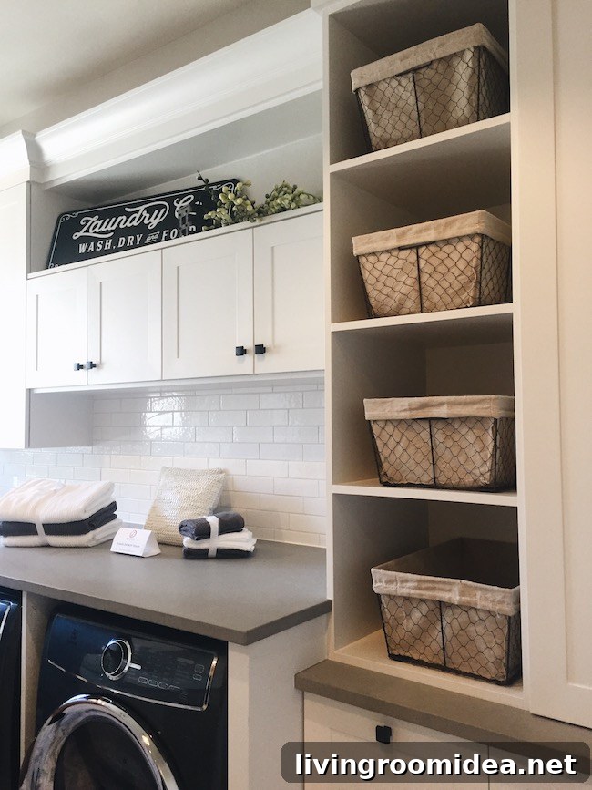 Inside a Modern Farmhouse: Street of Dreams Home Tour 32 Laundry Room Design - White Cabinets - Black Appliances - Wire Baskets