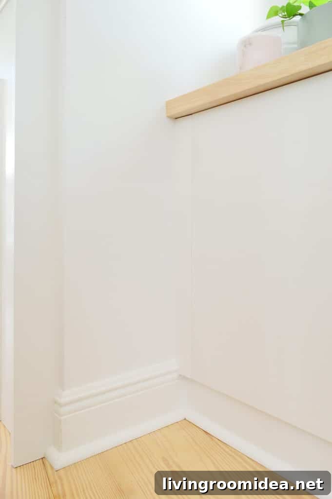 Close up detail of trim added to side of Ikea Besta cabinets to look flush with doors