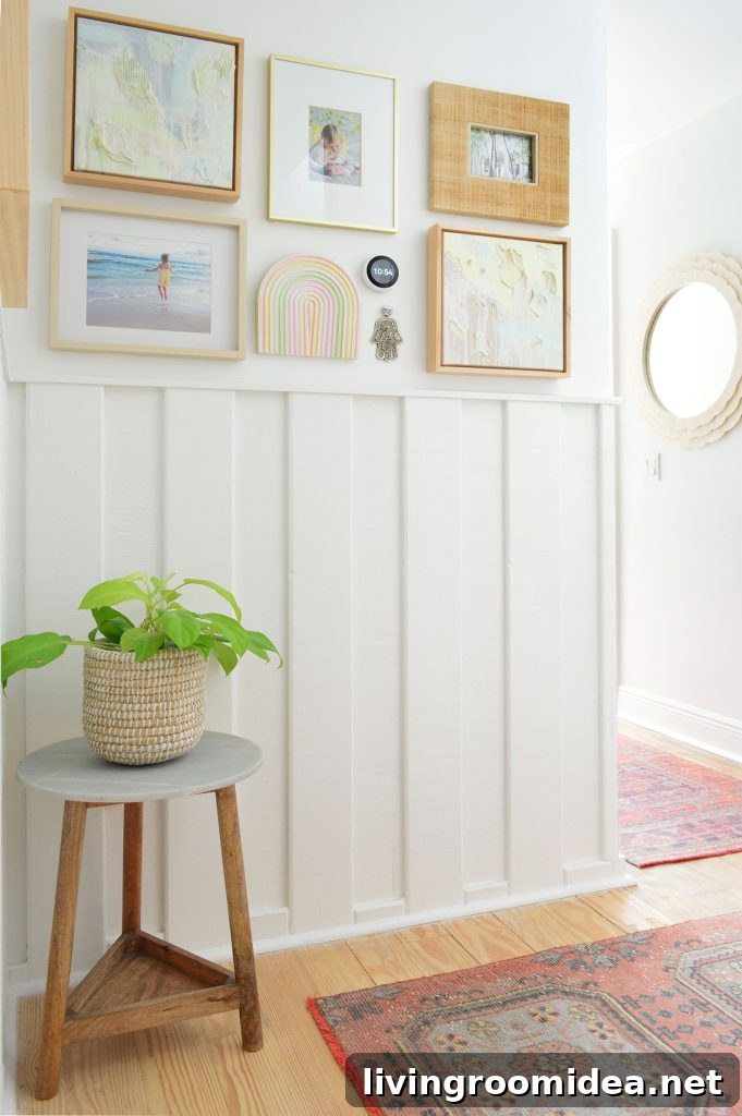 White hallway with wainscoting and picture frame collage and turkish runner rugs