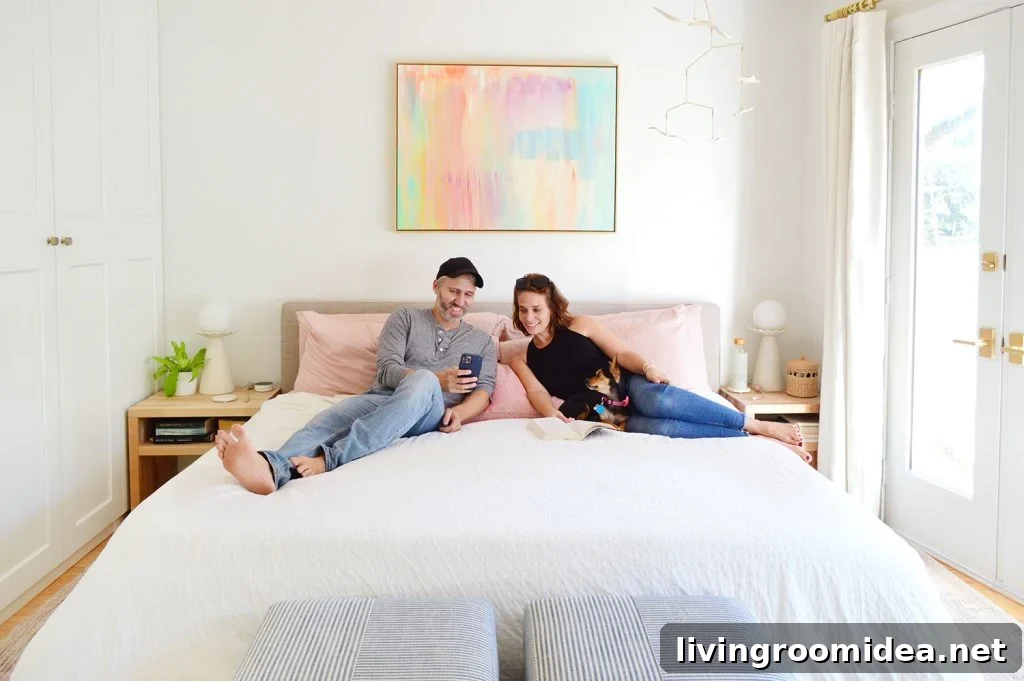 John And Sherry Looking At Phone With Dog On King Size Bed