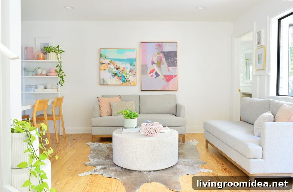 White Kitchen Sitting Area With Two Loveseats And Colorful Artwork