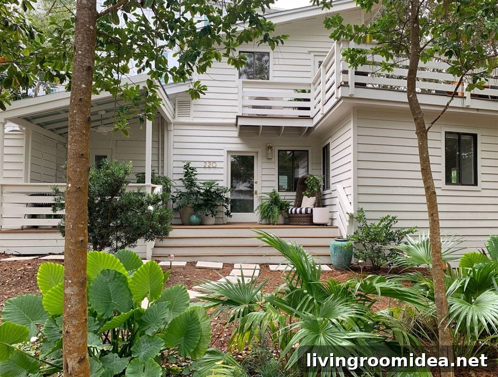 Renovating Our Home After Five Years Living Here 5 House With White Siding And Tropical Plantings
