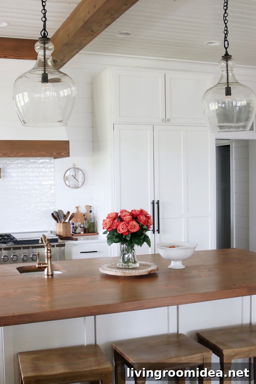 Shingle-Style Beach House Tour in Seabrook, WA 20 Kitchen island with glass lighting