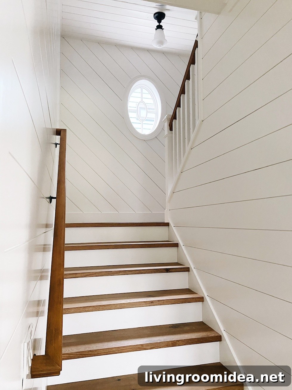 Shingle-Style Beach House Tour in Seabrook, WA 38 Staircase with shiplap and oval window