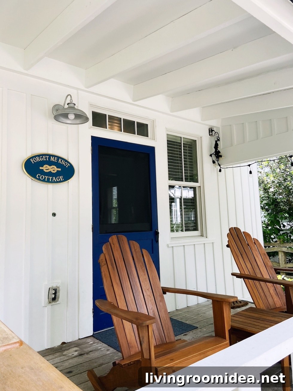 White beach house with adirondack chairs