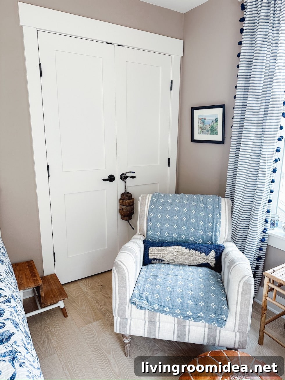 Upstairs Wood Floors Installed, Fresh Paint, and Moving In Updates 12 striped chair and whale pillow in a coastal guest room