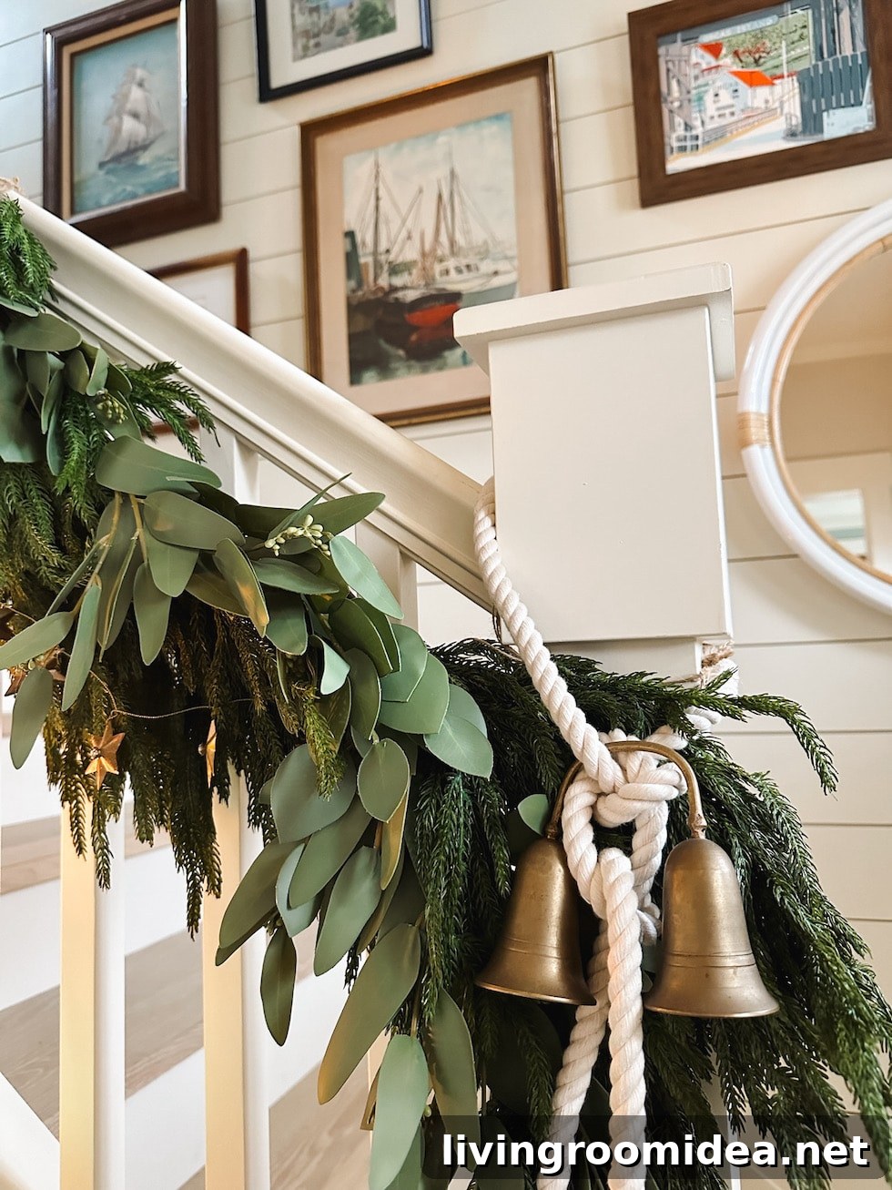 Coastal home Christmas staircase with mixed greens and rope