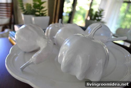 White painted gourds arranged on a cake stand
