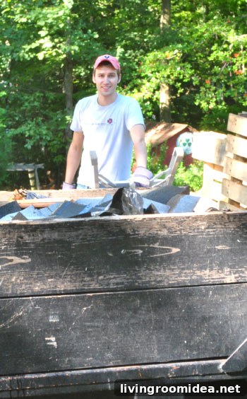 John tossing bags into dumpster
