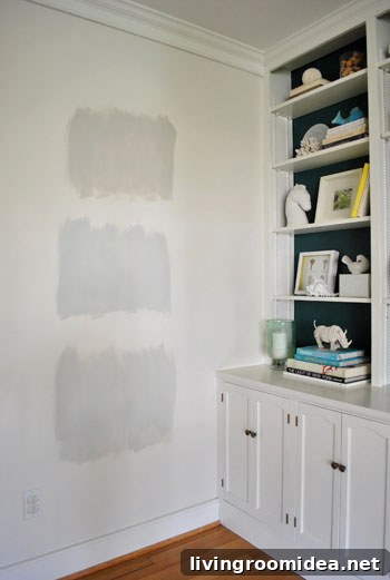 test areas of three Benjamin Moore gray paint colors applies to an area of white wall