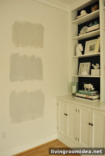 testing gray paint swatch colors on the wall during nighttime light