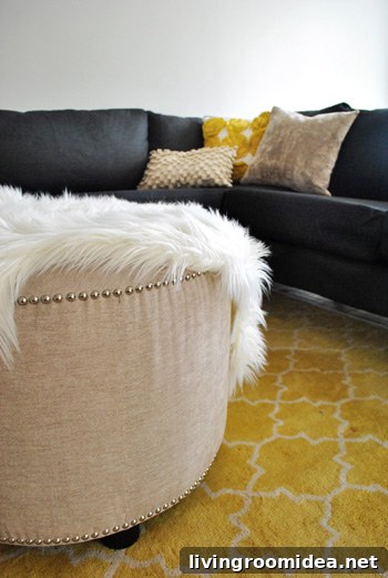 How We Assembled the IKEA Karlstad Sectional Sofa Step-by-Step 8 large round upholstered ottoman with nail head trim atop yellow pottery barn rug