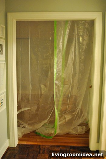 Doorway sealed with plastic sheeting and painter's tape