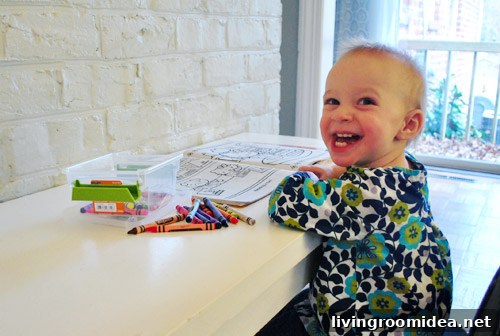 DIY Kids Art Desk Built Into a Cabinet Door: Step-by-Step Guide 15 Clara smiling at her desk