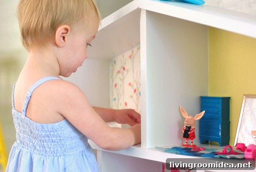 Creative Dollhouse Decorating Ideas for Charming Miniature Rooms 23 Close Up of Little Girl Playing With Olivia Pig Figurines In Homemade Dollhouse