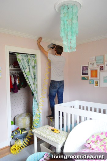 John nailing crown molding to ceiling using compressor and nail gun