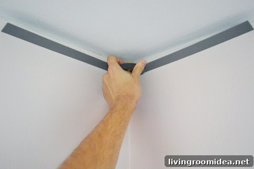 John measuring corner of ceiling wall with angle finder tool
