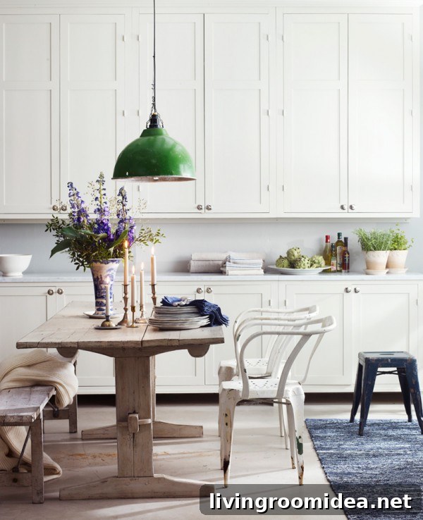 White Kitchen with Green Industrial Pendant Light and Rustic Wood Dining Table