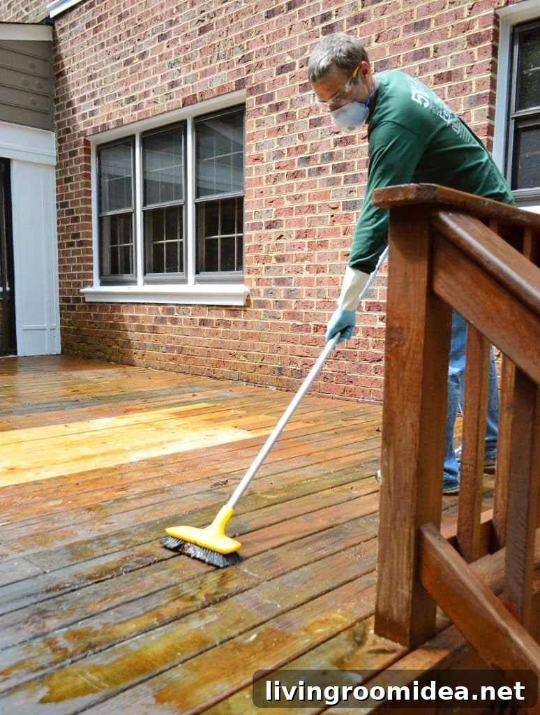 How to Strip a Deck for Staining: Step-by-Step Guide 11 John Scrubbing wood deck to remove old finish with stiff brush