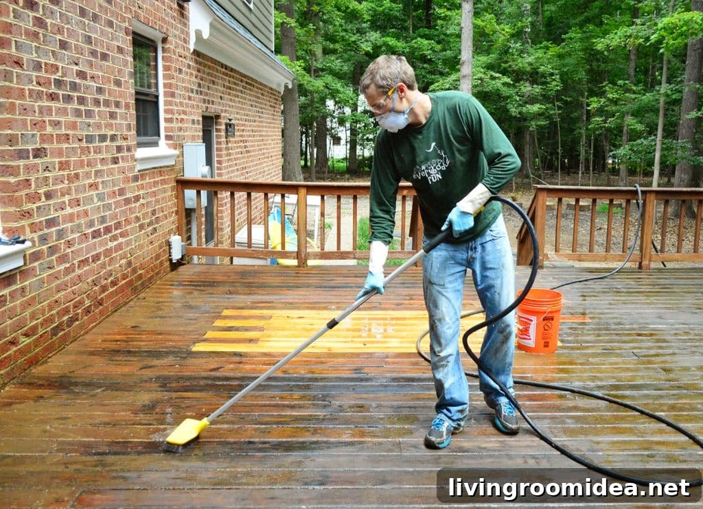 How to Strip a Deck for Staining: Step-by-Step Guide 13 John scrubbing deck with brush attached to hose