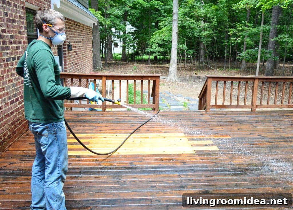 How to Strip a Deck for Staining: Step-by-Step Guide 14 John rinsing stripper finish off of wood deck