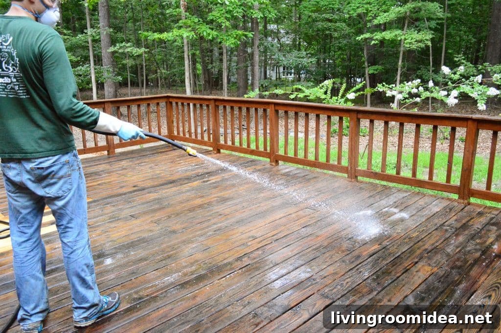 How to Strip a Deck for Staining: Step-by-Step Guide 17 John rinsing deck cleaner off with garden hose