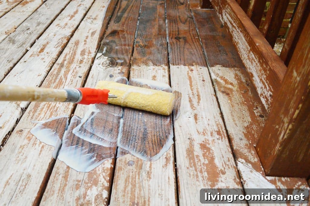 How to Strip a Deck for Staining: Step-by-Step Guide 10 Rolling deck finish stripper onto wood deck