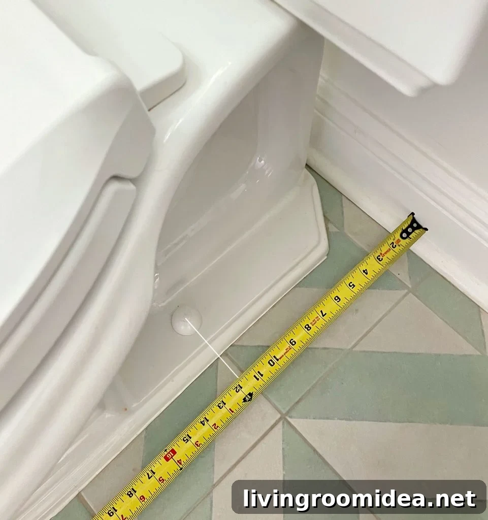 Tape Measure Taking Rough In Measurement By Toilet Bowl