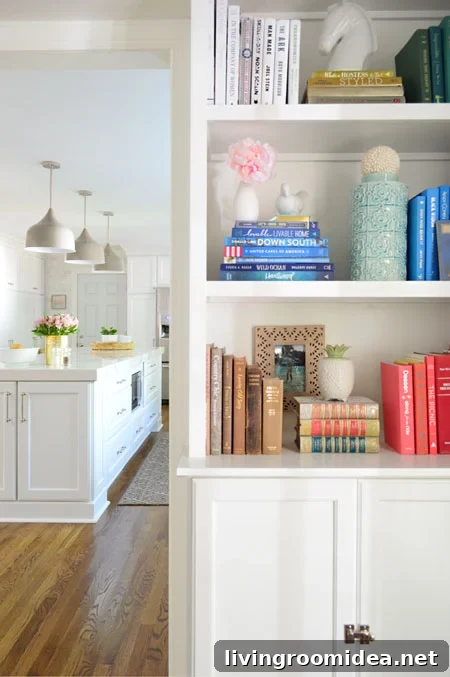 white built-in bookshelves with kitchen in background