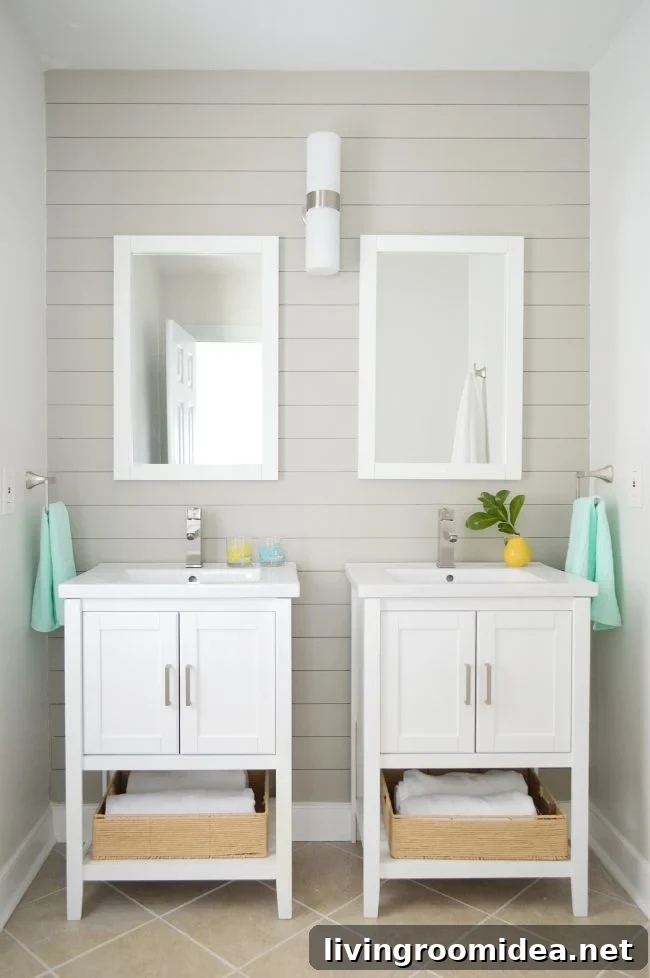 pair of vanities in bathroom staged to sell with gray shiplap wall