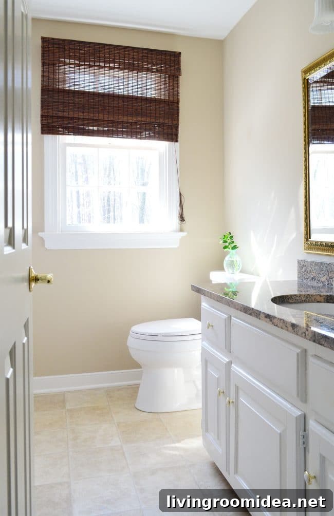 simple clean bathroom staged in house with no bathmat and clean counter