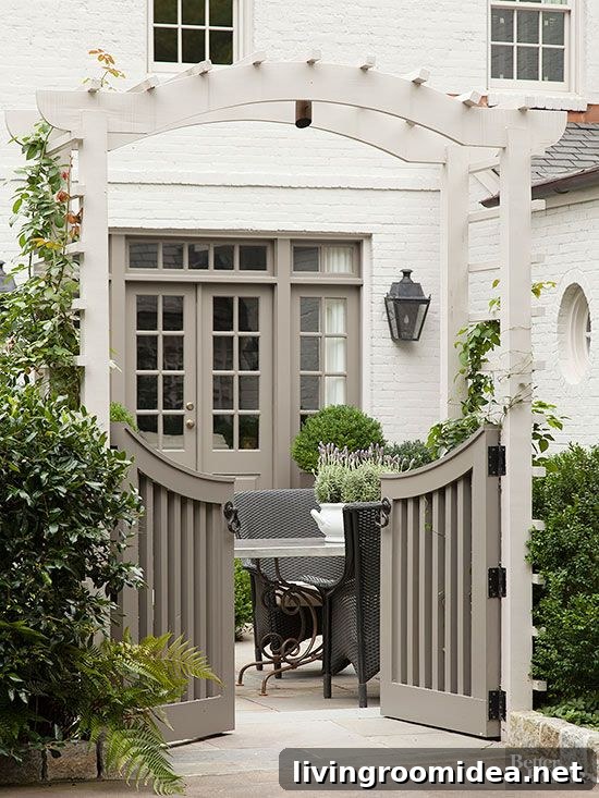 Curved Garden Gate with Arbor and Hedge - Painted White Brick House