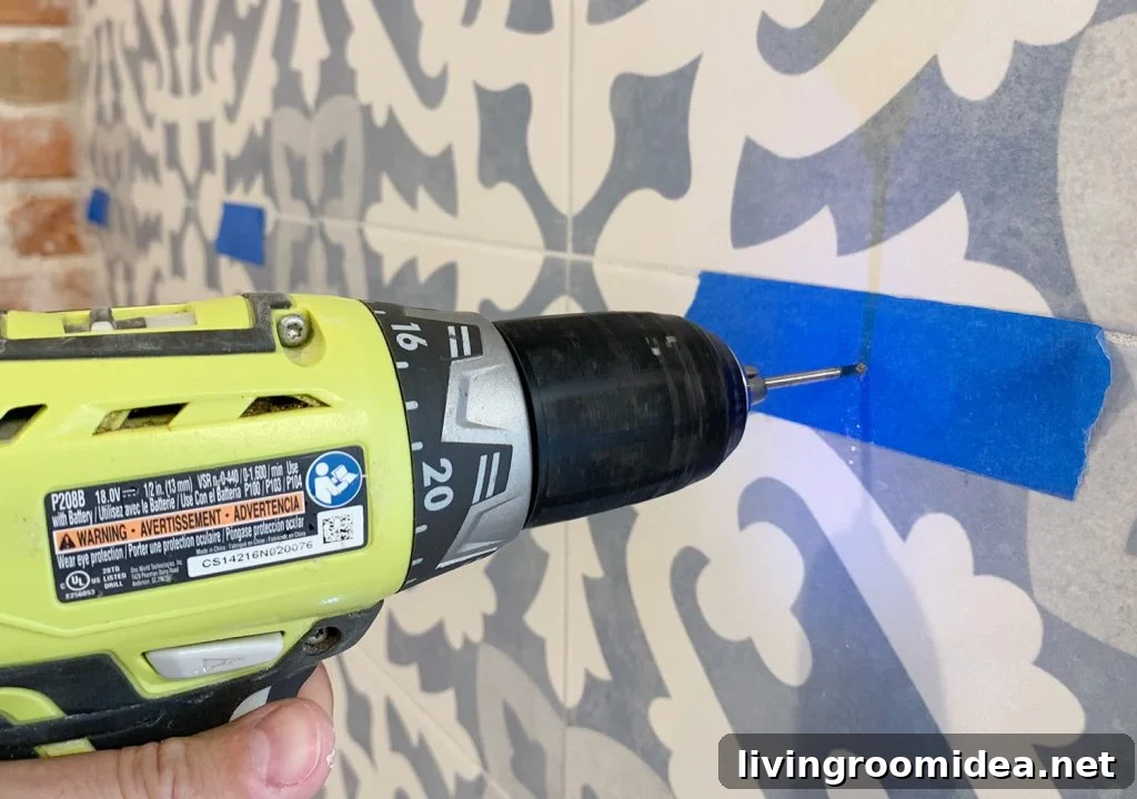 Drilling Through Tile Backsplash Using Marked Spot With Painters Tpae