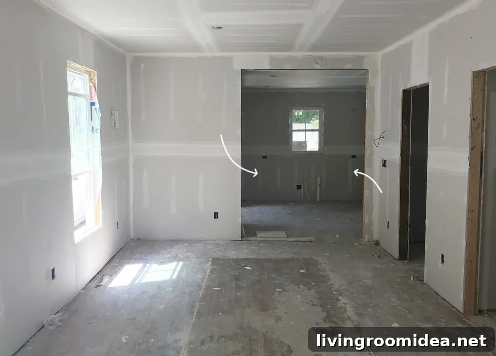 Unfinished Drywall In Duplex Renovation With Kitchen In Background
