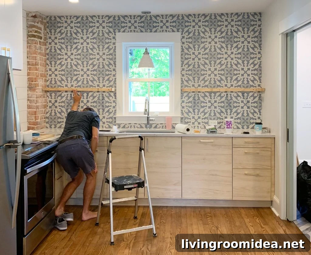 Man Holding Up Shelf Support Brackets Against Tile Backsplash