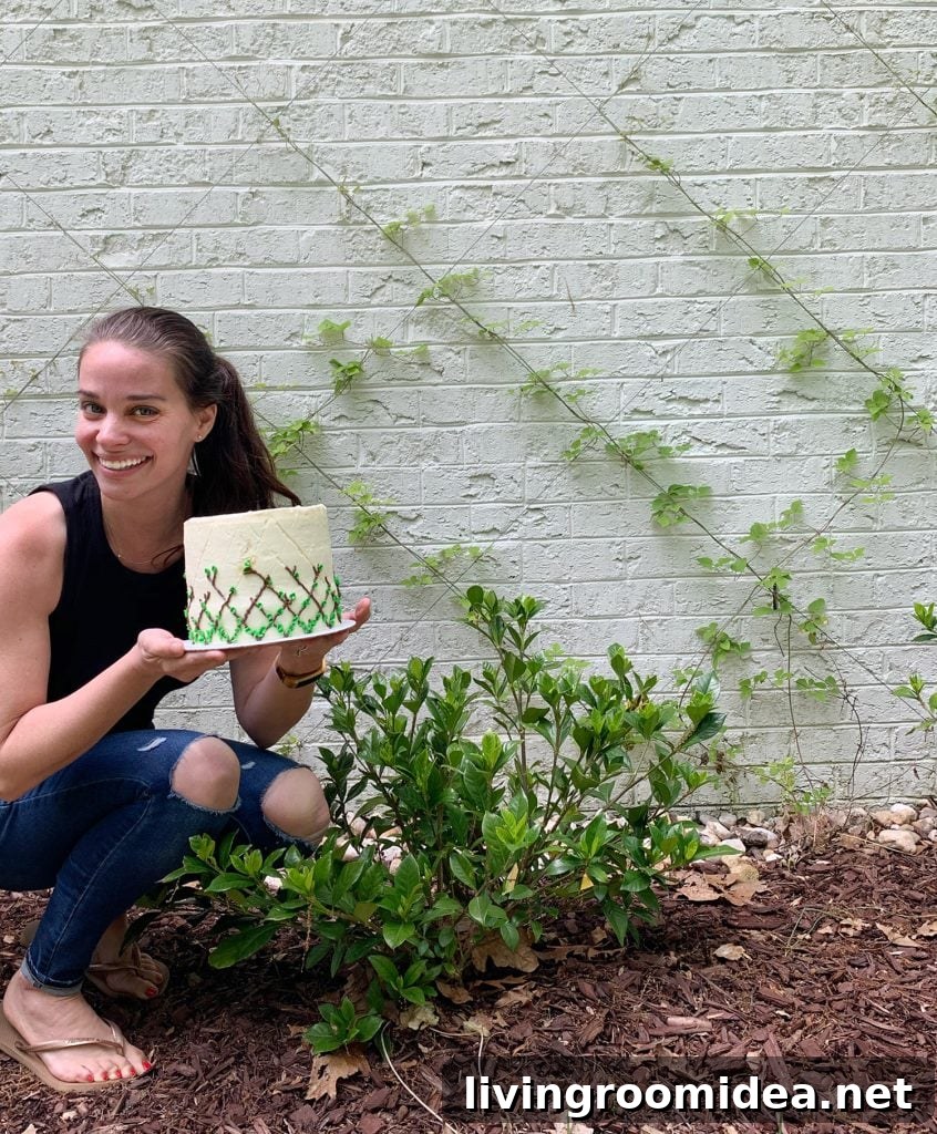 Sherry posing next to wire trellis with vine decorated cake