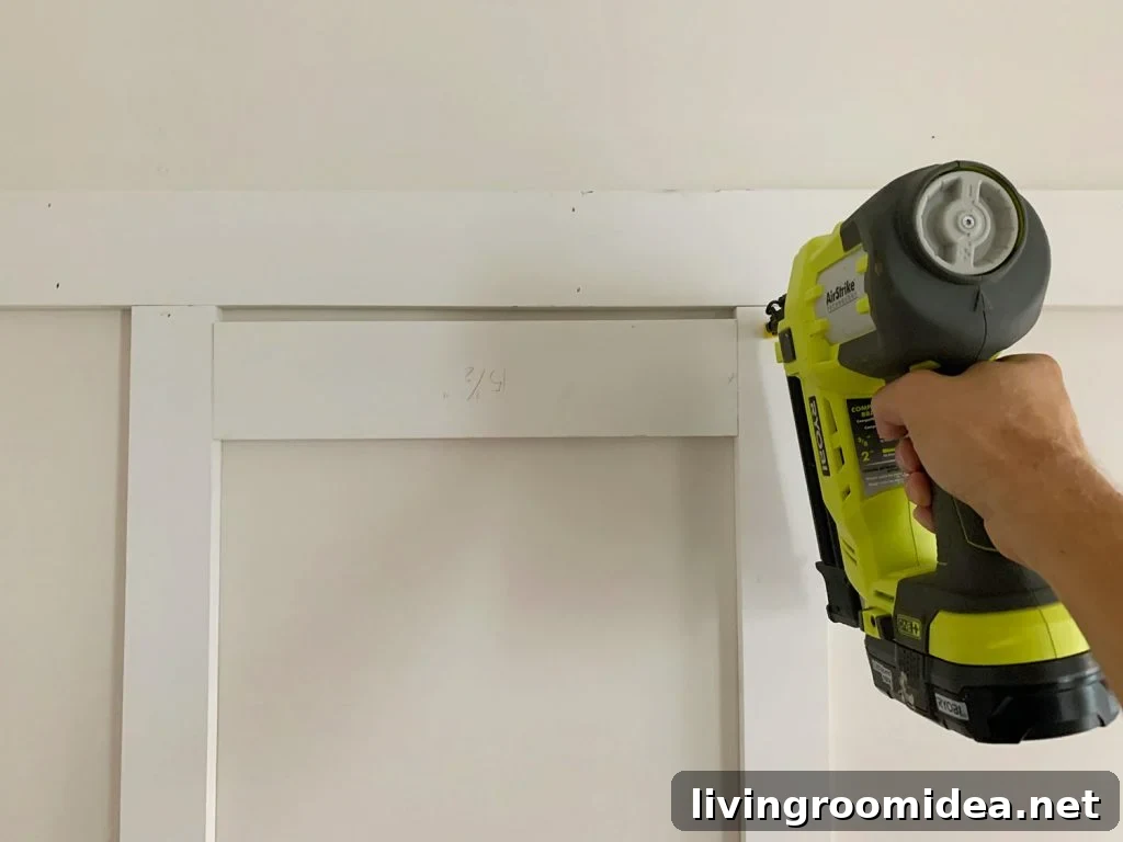 Board and Batten Tutorial: Step-by-Step Wall Installation Guide 11 Installing Vertical Battens Using Nail Gun And Wood Spacer