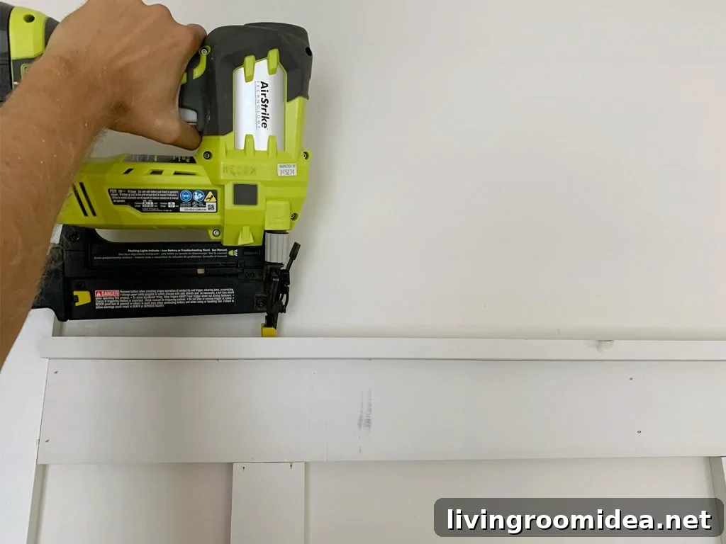 Board and Batten Tutorial: Step-by-Step Wall Installation Guide 13 Nail Gun Attaching Top Rail Lip Across Board And Batten