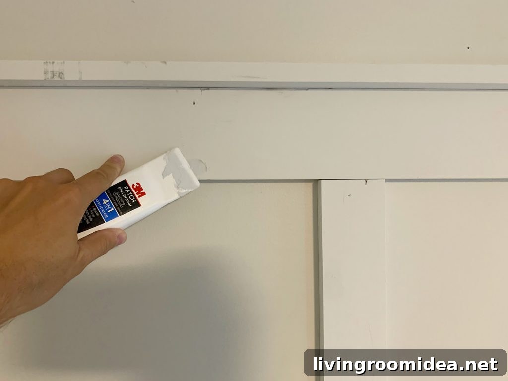 Board and Batten Tutorial: Step-by-Step Wall Installation Guide 14 Using Spackling Tool To Fill Nail Holes On Board And Batten
