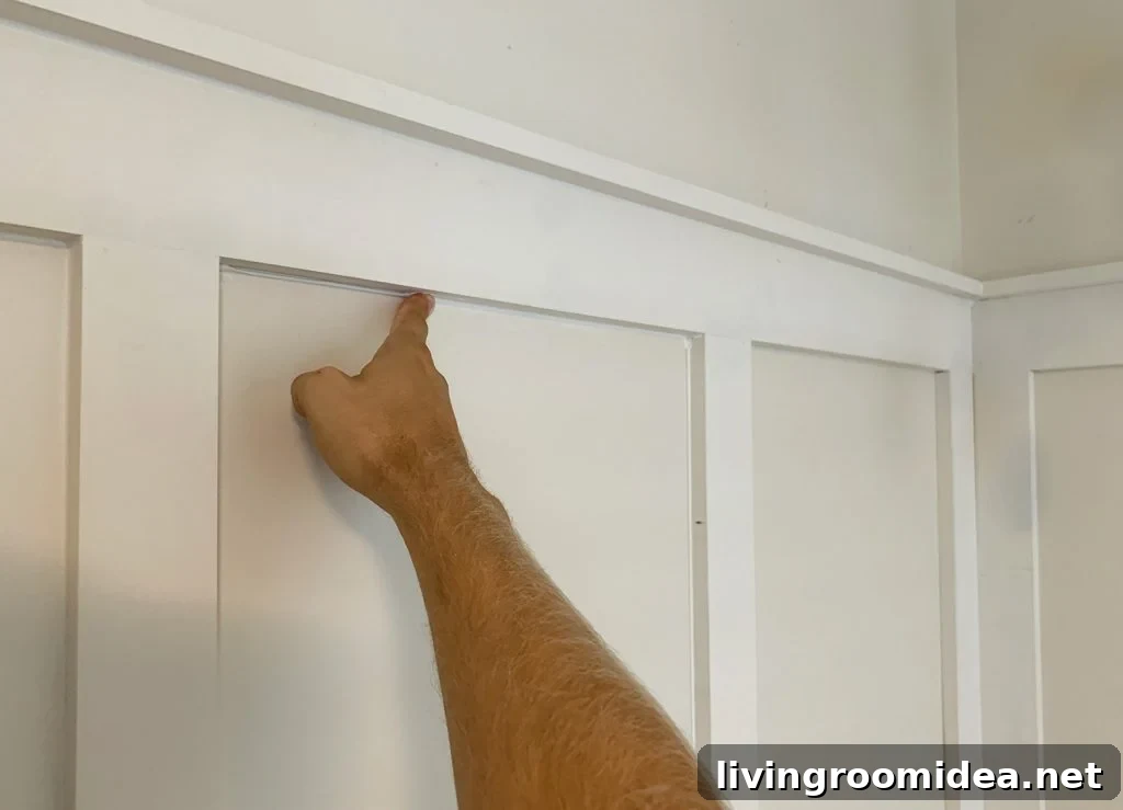 Board and Batten Tutorial: Step-by-Step Wall Installation Guide 16 Finger Wiping Caulk Smooth Along Seams In Board And Batten