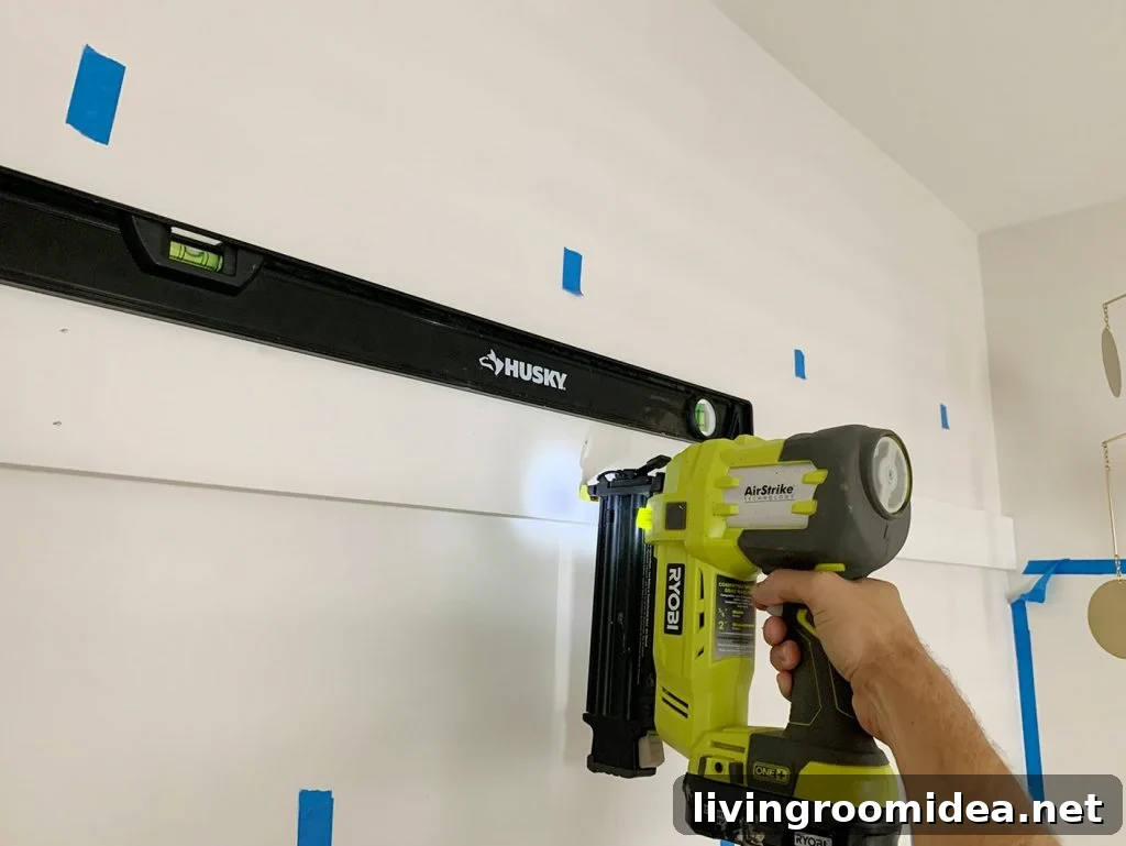 Board and Batten Tutorial: Step-by-Step Wall Installation Guide 10 Using Nail Gun To Install Top Rail Of Board And Batten