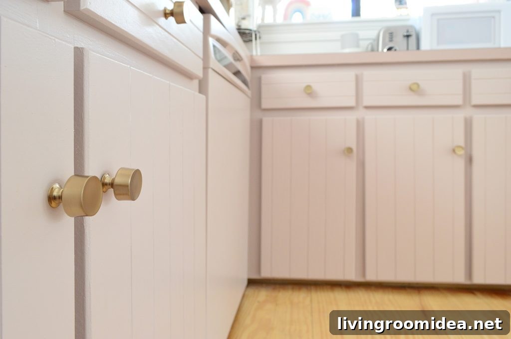 Close up after photo of mauve cabinets with brass gold hardware knobs