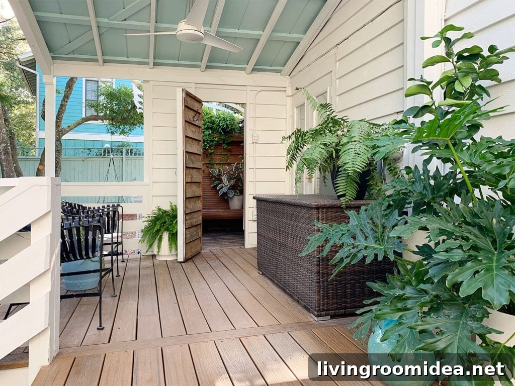 Covered Porch With Blue Ceiling And Open Door To Outdoor Shower