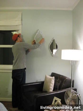 john-hangs-the-sconces-on-the-wall john-hangs-the-sconces-on-the-wall