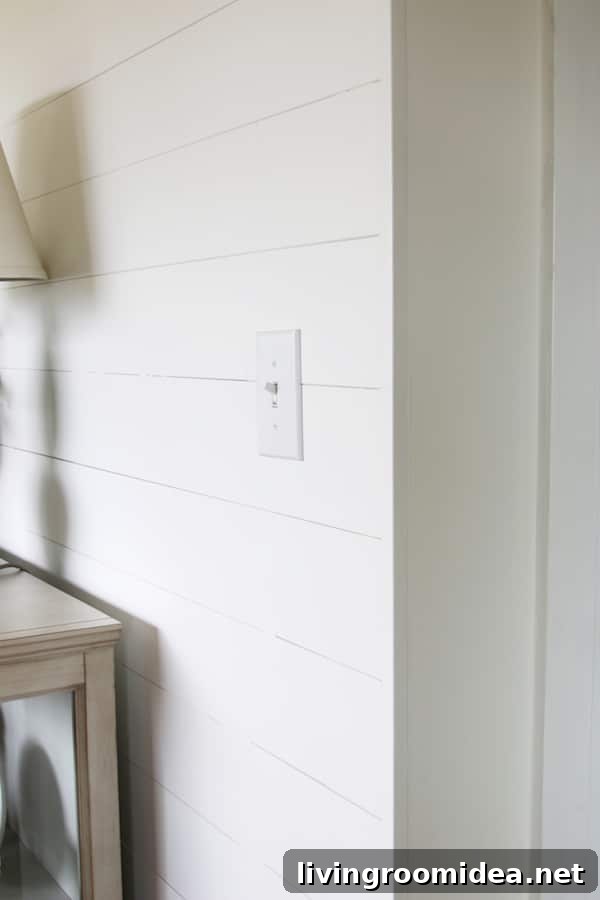 Side view of shiplap paneling, corner piece - The Inspired Room. This post answers FAQ on installing DIY shiplap walls. What wood or MDF to use for shiplap and what to do with the corner edges after install.
