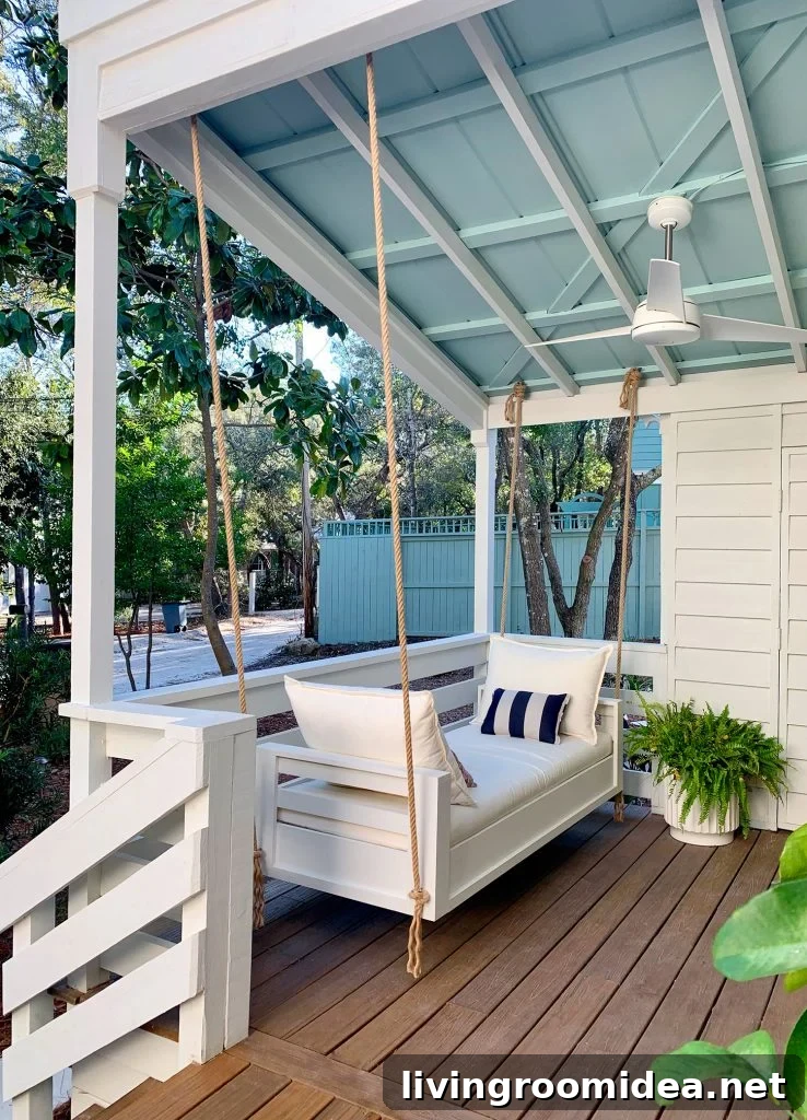 Outdoor Hanging Daybed Hung With Rope In Four Spots Under Covered Porch Ceiling