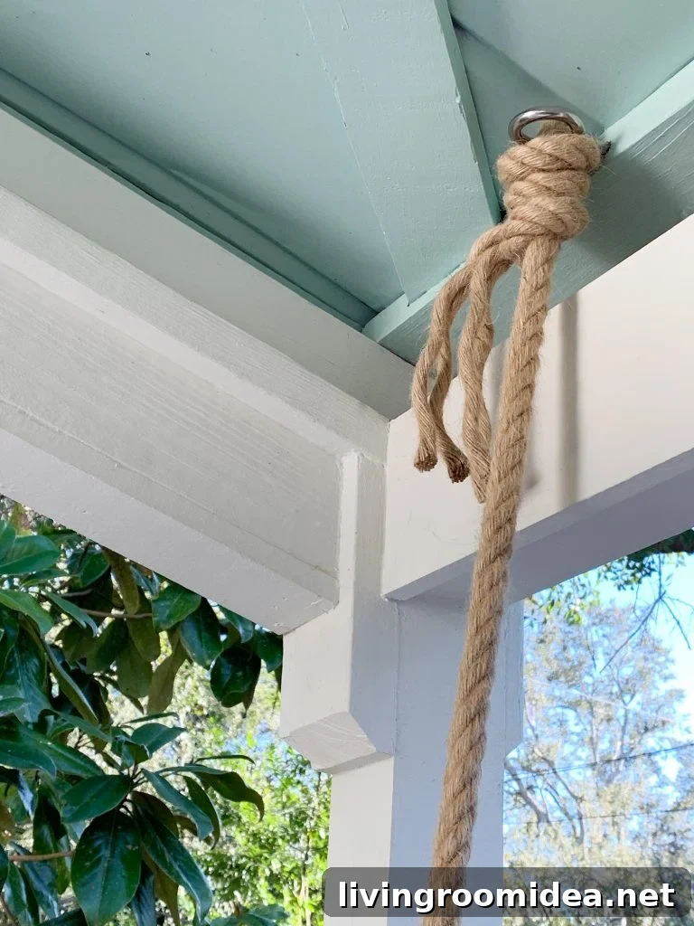 Rope knotted around screw eye hook in ceiling of covered porch