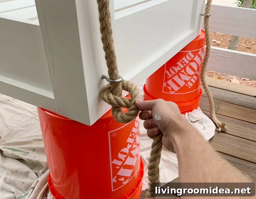 Typing pretzel knot on the bottom of hanging daybed under eyehook